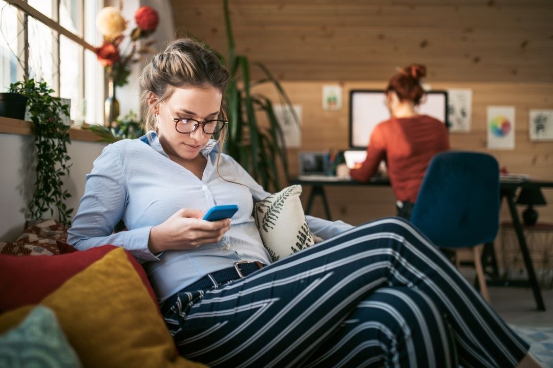 photo of women playing mobile games